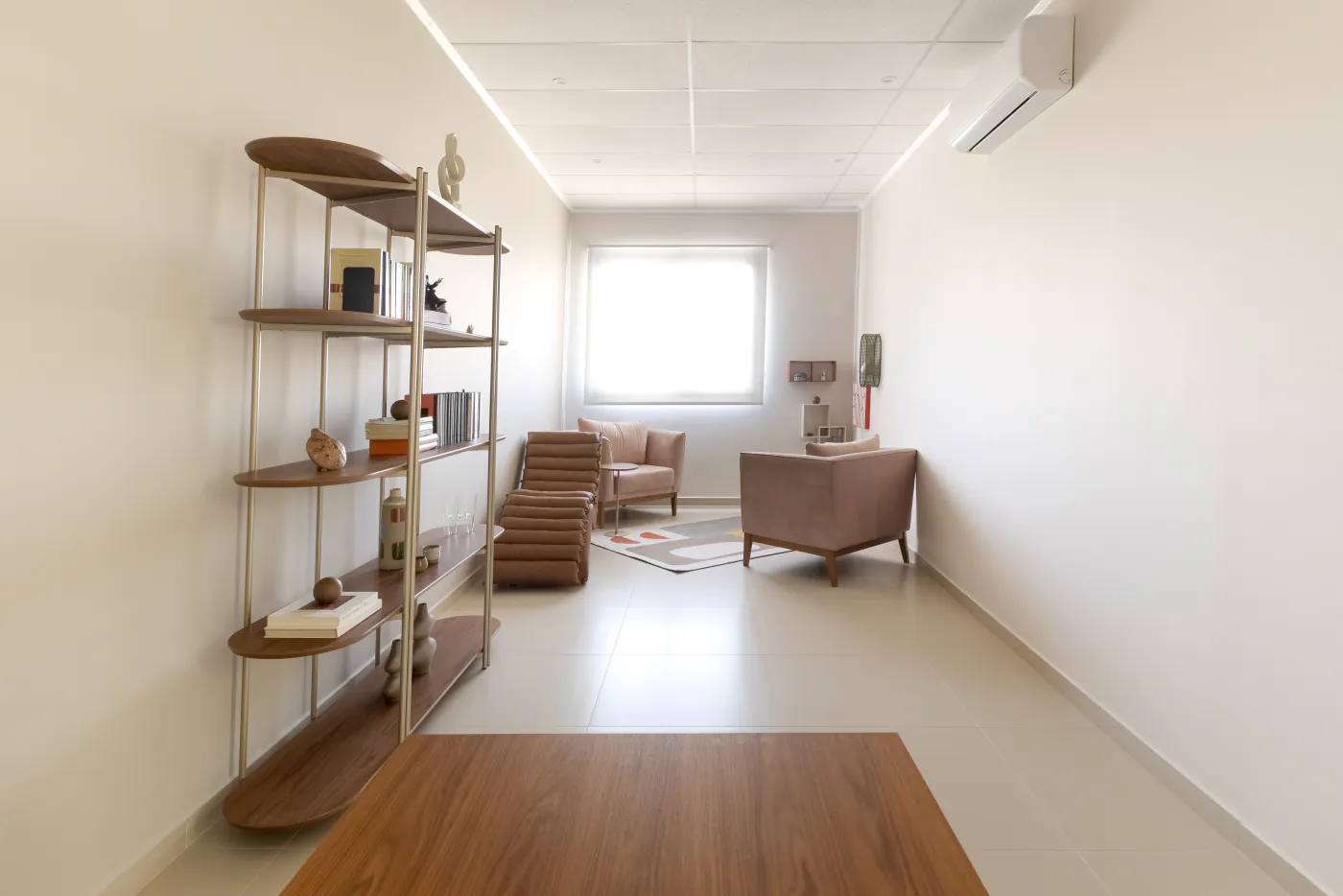 Sala de psicologia do LYRATA com poltronas, chaise e estante de livros